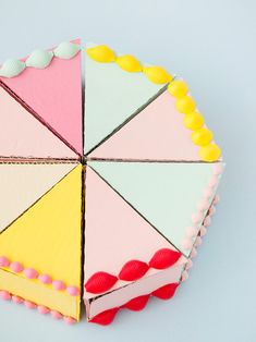 a cake decorated with multicolored icing sitting on top of a blue surface