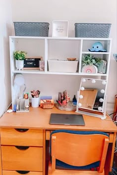 a wooden desk topped with drawers next to a shelf filled with books and other items