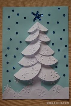 a card with a christmas tree made out of white paper and blue dots on it