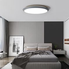 a modern bedroom with black and white stripes on the wall behind the bed is an art piece