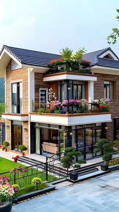 a large house with lots of windows and balconies on the second floor, surrounded by greenery