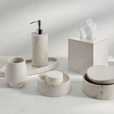 bathroom accessories including soap dispenser, toothbrush holder and toilet paper roll