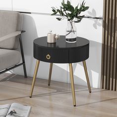 a black table with gold legs and a potted plant sitting on top of it