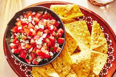 a bowl of salsa and tortilla chips on a plate