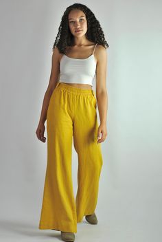 "This is our no. 83 of our Conscious Clothing Concept. This fantastic summer sunny yellow loose fitting elasticated pants are made of pure softened European linen. They are great for a casual style as well as the elegant evening. Very cconfident and elegant summer look. It has got 2 pockets on the back and 2 pockets on the sides. It is the ultimate fabric for hot weather as it breathes and absorbs moisture better that any fabric on earth. This time the fabric is heavier that usual, which makes t Flared Solid Bottoms For Summer, Flare Bottoms In Solid Color For Summer, Solid Flare Bottoms For Summer, Summer Solid Color Flare Bottoms, Yellow Relaxed Fit Wide Leg Casual Pants, Casual Yellow Relaxed Fit Wide Leg Pants, Yellow Wide Leg Bottoms With Elastic Waistband, Yellow Wide Leg Pants With Elastic Waistband For Summer, Casual Yellow Wide Leg Pants With Relaxed Fit