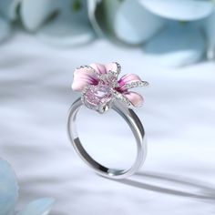 Turn up the flower power with this pink flower ring. Crafted in sterling silver, features every petals hand-painted in rich enamel, decorated with white stones, making every flower completely unique. An organically shaped band mimics a real stem and evokes the freedom of spring. Wear yours as a reminder of all the loved ones in your life.Carat Weight: 2.31 ctStone Shape: Oval, RoundStone Size: 6*8,1,1.2 mmNumber of Stones: 30 Stone Color: Diamond WhiteWeight: 4.3 gWidth: 2.4 mmHeight: 9 mmThickn Pink Enamel Flower-shaped Jewelry, Pink Enamel Rings For Gift, Fine Jewelry Pink Enamel Ring, Pink Enamel Promise Ring, Fine Pink Enamel Rings, Pink Enamel Ring For Wedding, Enamel Flower-shaped Jewelry For Wedding, Pink Enamel Jewelry With Flower Charm, Flower-shaped Enamel Jewelry For Wedding