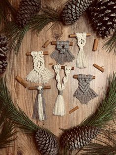 some pine cones and other decorations on a wooden table with pine cones, cinnamon sticks and needles