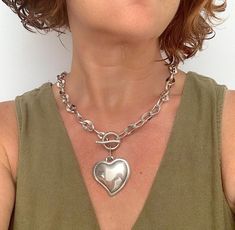 Make a bold statement with this chunky silver heart necklace, featuring a thick chain and an oversized heart-shaped pendant. This piece of statement jewelry exudes contemporary elegance and is perfect for adding a touch of glamour to any outfit. Whether worn alone or layered with other pieces, this necklace is sure to stand out and make an impact. 🔸 In the photo, the model wears a necklace length of 18" / 46 cm. MADE OF: All my pieces are made of silver-plated Zamak. Have a 100% European qualit Chunky Metal Necklace With Heart Pendant, Chunky Metal Heart Pendant Necklace, Chunky Heart Pendant Necklace For Valentine's Day, Chunky Heart Necklace For Valentine's Day, Silver Heart Necklace With Chunky Chain, Trendy Silver Heart Necklace With Chunky Chain, Silver Heart Shaped Chain Necklace With Chunky Chain, Valentine's Day Silver Heart Necklace With Chunky Chain, Chunky Heart Pendant Jewelry Gift