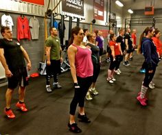 a group of people standing in a gym