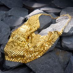 This fantastically stylish Italian necklace features gold mesh, which falls along the neckline in a triangular shape. It folds and ripples softly and beautofully, almost emulating fabric. It is crafted in solid 14k yellow gold and hangs 17 inches in length. It is finished with a lobster claw clasp. Luxury Gold Necklaces For Party, Luxury Gold Necklace For Parties, Elegant Chainmail Necklaces For Party, Elegant Gold Triangle Necklace, Elegant Chainmail Necklace For Party, Elegant Gold Bib Necklace For Evening, Mesh Jewelry, Italian Necklace, Lobster Claw