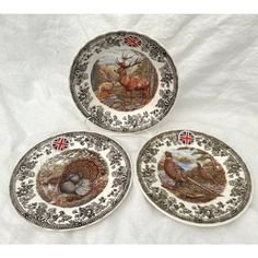 three plates with animals painted on them