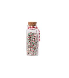 a glass jar filled with sprinkles on top of a white surface