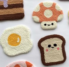 crocheted coasters with different types of bread and eggs on them, including mushrooms