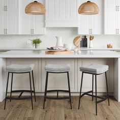 two stools sit at the center of a kitchen island