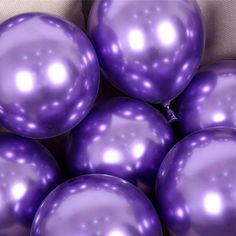 a bunch of shiny purple balls sitting on top of each other