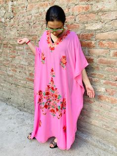 Our gorgeous high quality boho maxi dress kaftan combines 100% fine cotton with stunning Kashmiri embroidery. The embroidery is in the neckline and over the body, with a smaller embroidered detail on the back. Best choice for the summer, you can wear this model for plenty of occasions, morning to evening. Feels comfortable, chic and cool. The best choice to impress, you'll look divinely beautiful in this chic boho dress with slightly oriental flare. Fits all size - up to XL and looks great on an Spring V-neck Kaftan With Chikankari Embroidery, Pink V-neck Kaftan For Eid, Bohemian V-neck Kaftan For Eid, Pink V-neck Kaftan For Summer, Pink Floral Embroidery Floor-length Maxi Dress, Traditional Pink Kaftan For Beach Cover-up, Traditional Pink Embroidered Maxi Dress, Traditional Pink Maxi Length Abaya, Traditional Pink Floor-length Maxi Dress