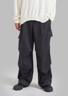 Color: Grey Unisex style Midweight soft woven fabric Relaxed fit High rise Wide leg Front pleat detailing Slant hip pockets Enlarged illusion cargo pockets on leg Darted detailing Zip fly Front button closure Unlined 78% Polyester 20% Rayon 2% Polyurethane Dry Clean By The Frankie Shop. Imported Gray Tapered Leg Cargo Pants With Pockets, Solid Techwear Bottoms With Cargo Pockets, Relaxed Fit Gray Cargo Pants, Techwear Full-length Work Pants With Cargo Pockets, Techwear Wide Leg Bottoms With Patch Pockets, Relaxed Fit Gray Full-length Cargo Pants, Relaxed Fit Full Length Gray Cargo Pants, Urban Bottoms With Pockets For Workwear, Gray Casual Cargo Pants With Patch Pockets