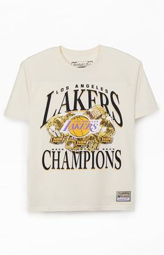 Treat yourself to a fresh pick from Mitchell & Ness with the new  Los Angeles Lakers Champions T-Shirt. This retro tee has a bold vibe with printed graphics on the front, a comfortable crew neckline, short sleeves, regular fit, and woven Hardwood Classics tag at the left hem.


	Crew neckline
	Short sleeves
	Standard fit
	Front graphic
	100% Cotton
	Machine washable Cream Letter Print Top For Streetwear, Cream Graphic Print Top For Streetwear, Cream Screen Print T-shirt For Streetwear, Cream Cotton T-shirt With Graphic Print, Cream Cotton T-shirt For Streetwear, Cream Logo Print Top For Streetwear, Lakers Shirt Outfit, Cream T-shirt With Text Print For Streetwear, Cream Text Print T-shirt For Streetwear