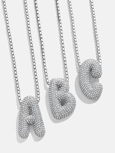 Orders placed between 11/30 - 12/6 will be ship between 12/28 - 1/3/25.Opt for this classic initial necklace with a modern twist. The Pavé Bubble Initial Necklace features a box chain attached to an initial crystal pendant. Each letter is crafted in a fun, 3D-inspired bubble font. Choose your initial or that of a loved one and stack it every single day. Silver Initial Pendant For Party, Silver Initial Pendant Party Jewelry, Silver Initial Pendant Jewelry For Party, Trendy Silver Letter Beads Necklace, Trendy Silver Jewelry With Initials, Silver Initial Necklace With Letter Beads For Anniversary, Modern Silver Initial Pendant Name Necklace, Silver Cubic Zirconia Initial Necklace For Gift, Modern Silver Initial Pendant Jewelry