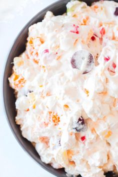 a bowl filled with fruit salad on top of a table