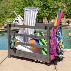 an inflatable unicorn sitting on top of a pool next to a tall glass vase