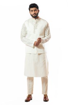 Ivory Nehru jacket with placement bead-pipe cutdana work and welt pocket.
Components:1
Embroidered
Neckline:Mandarin Collar
Sleeve Length:Sleeveless
Fabric:Linen Satin
Color:White
Welt pocket
Closure: Concealed front placket
Note: Kurta and pant worn by the model is not for sale - Aza Fashions Nehru Jacket For Men, Silk Kurta Set, Silk Pajama Pants, Nehru Jacket, Silk Kurta, Nehru Jackets, Pajama Pant, Embroidered Neckline, Indian Fashion Designers