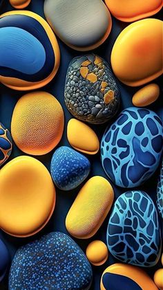 colorful rocks and pebbles are arranged in an abstract pattern, with blue, orange, and yellow colors