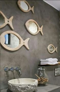 a bathroom with two fish on the wall