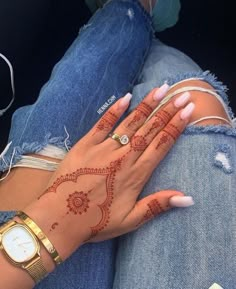 a woman with henna on her hand and wrist