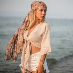 "Stay cool and fresh in this lightweight tank, crafted from breathable linen, one of our most beloved fabrics for its luxurious hand feel. The linen crop tops are designed with an adjustable wrap fit that can be adjusted from both the front and back, making it suitable for any body type. It's made of 100% natural, medium-weight linen that's been soft-washed and Oeko-Tex certified.  The linen is lightweight and breathable, making it perfect for any occasion, from formal events to casual outings with friends.  Size Bust: 39\" inches-98cm Waist: 29\" inches-73cm It is completely organic and hypoallergenic, making it perfect for those with sensitive skin. Care To care for the dress, wash it in lukewarm water at 40oC/104oF. Be careful not to use high temperatures, as this may cause shrinkage of Beige Summer Festival Blouse, Summer Festival Beige Blouse, Vacation Linen Top In Flax Color, Breezy Linen Tops For Summer, Breezy Linen Tops For Vacation, Linen Beachwear Tops For Summer, Linen Beachwear Tops For Vacation, Linen Tops For Beach Season Vacation, Linen Tops For Summer Beachwear