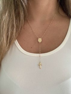 "This 14K yellow gold rosary necklace is the perfect religious symbol of faith. Featuring a cross pendant, shiny diamond cut 2.5mm round beads, and a 20\" chain, this necklace is a meaningful piece of Catholic jewelry. Its delicate design makes it an ideal gift for anniversaries, confirmations, 1st communion and other special occasions. ♦ Materials: 14K Solid Gold ♦ Available colors: Gold  ♦ Necklace measurements: 20\" total length, beads are 2.5MM ♦ Beads measurements: Beads are 2.5MM and diamo Adjustable Crucifix Chain Jewelry, Spiritual Cross Necklace With Adjustable Chain, Spiritual Crucifix Cross Necklace For Jewelry Making, Yellow Gold Cross Rosary As Gift, Yellow Gold Rosary With Miraculous Medal As Gift, Personalized Spiritual Crucifix Necklace, Gold Cross Rosary In Spiritual Style, Gold Cross Rosary Spiritual, Gold Spiritual Rosary With Cross