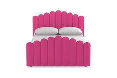 a pink bed with two pillows on top of it and an upholstered headboard