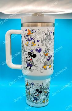 the mickey mouse travel mug has been painted with disney characters and is ready to be used