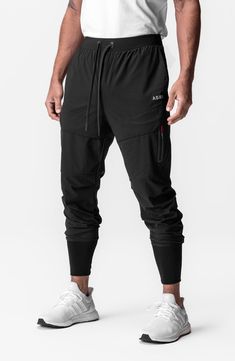 Lightweight, stretchy and ready to conquer the elements, these water-repellent joggers sport a higher waist and tall, stay-put ribbing circling the ankles. 28 1/2" inseam; 7 1/2" leg opening; 12 1/2" front rise; 16 1/2" back rise (size Medium) Elastic/drawstring waist Front slant pockets; back welt pocket Tetra-Lite fabric offers lots of stretch plus durable water-repellent (DWR) protection against the elements. 78% nylon, 22% spandex Machine wash, line dry Imported Black Breathable 4-way Stretch Pants, Breathable Functional Pants For Outdoor Activities, Sporty Activewear With 4-way Stretch And Breathable Fabric, Breathable Functional Outdoor Pants, Breathable Functional Pants For Outdoor, Breathable Techwear Bottoms For Outdoor, Breathable Techwear Bottoms For Workout, Moisture-wicking Stretch Sweatpants For Outdoor Activities, Stretch Moisture-wicking Sweatpants For Outdoor