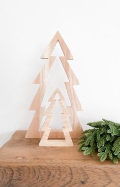 a wooden christmas tree sitting on top of a table