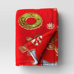 a red blanket with christmas decorations on it