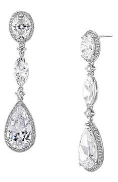 Accessorize in dazzling style with these hand-polished drop earrings set with sparkling crystals and plated in rhodium or 18-karat gold. 1 3/4" drop; 3/8" width 18k-gold plate or rhodium plate/cubic zirconia Imported Teardrop Chandelier Earrings With Diamond Accents For Formal Occasions, Formal Teardrop Chandelier Earrings With Diamond Accents, Elegant Pear-shaped Chandelier Earrings For Formal Occasions, Dazzling Crystal Drop Chandelier Earrings, Formal Teardrop Chandelier Earrings In White Gold, Classic Cubic Zirconia Chandelier Earrings For Formal Occasions, Cubic Zirconia Drop Chandelier Earrings, Classic Formal Chandelier Earrings In Cubic Zirconia, Pear-shaped Cubic Zirconia Diamond Earrings For Evening