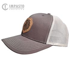 "Lion design engraved leather patch hat. Laser Engraved Leather patch hat. Brown Khaki Richardson 112 Trucker Hat 1Permacurv visor Matching snapback closure 3 1/2\" mid-profile crown 8-row stitching on visor Matching undervisor 6-panel, structured, hard buckram backed front panels 65% polyester, 35% cotton" Brown Trucker Hat With Logo Patch For Outdoor, Brown Trucker Hat With Curved Brim, Brown Trucker Hat For Outdoor, Rugged Brown Baseball Cap, Brown Flat Bill Trucker Hat With Logo Patch, Brown Trucker Snapback Hat For Outdoor, Outdoor Brown Baseball Cap With Logo Patch, Brown Outdoor Baseball Cap With Logo Patch, Adjustable Brown Trucker Baseball Cap