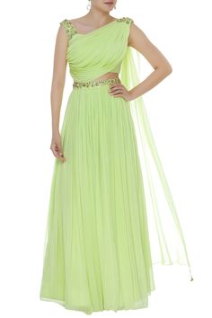 Bring a burst of color to any occasion with this lime green lehenga set featuring an embellished draped blouse with attached dupatta. It is highlighted with a pleated lehenga skirt with an embellished belt panel. 
Draped blouse
Attached dupatta
Swarovski embellish
Sequin detail - Aza Fashions Pleated Blouse Designs, Draped Blouse Pattern, Lehenga Green, Pleated Lehenga, Lehenga For Women, Embroidered Beads, Frocks And Gowns, Choli Dress, Draped Blouse