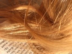 the hair is laying on top of an open book with some words written in it