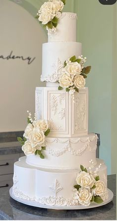 a white wedding cake with flowers on top