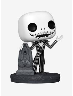 a skeleton figurine is holding a hand in front of a black and white background