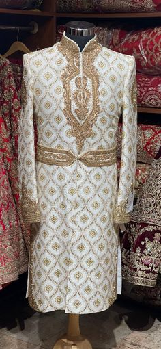 Mesmerize the crowd by your magnificent gaze in this off white pure raw silk fabricated wedding sherwani crafted in zardosi,bead,stone,resham & zari work with details embroidered waist belt. Available with matching bottoms chudidar. Size: 38,44 Ready to Ship! Ceremonial Clothing, Embroidered Sherwani, Wedding Sherwani, Zari Work, Extra Fabric, Churidar, Sherwani, Wedding Looks, Raw Silk