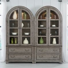 an old wooden china cabinet with glass doors