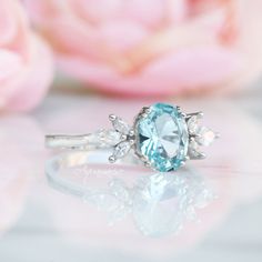 Gorgeous Eva Aquamarine Ring ►Made of solid sterling silver with rhodium finish (925) ►Accented with simulated diamonds (CZ) ►Average band width: 1.8 mm Center Stone: Aquamarine Stone Creation: Created (can be made with a natural aquamarine at additional cost) Stone Cut: Oval Gem size: 7.0 x 9.0 mm Carat Weight: 1.4 ct. (approx.) ✓ 100% Nickel-Free ✓ Hypoallergenic ✓ Comfort Fit ✓ Free Ring Box ✓ Free USA Shipping ✓ Ready to ship next business day Morganite Ring Set, Promise Rings Vintage, Design Birthday, Aquamarine Ring, Sterling Silver Engagement Rings, March Birthstone, Morganite Ring, Aquamarine Stone, Aquamarine Rings