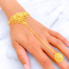 This exquisite 22k gold Panchangala bracelet, weighing 15.4 grams, features a glistening leaf-adorned design that exudes elegance and natural beauty. The yellow gold finish enhances its luxurious appeal, making it perfect for any special occasion. The bracelet has a length of 7.75 inches with adjustable 1.2-inch links and a hook lock for added convenience. It also includes an adjustable ring, fitting sizes 6 to 8, offering both style and comfort. Ideal for those who appreciate high-quality craftsmanship and timeless beauty, this leaf-adorned gold Panchangala bracelet is a cherished addition to any jewelry collection. PRODUCT DETAILS Gold Purity(karat): 22k Gold Weight(grams): 15.4 Item Finish: Yellow Gold Bracelet Length: 7.75" Adjustable Links: 1.2" Links Lock Style: Hook Lock Adjustable 22k Gold Bracelet, Bridal Jewelry Necklace, Precious Stones Rings, Diamond Pendant Sets, Modern Bracelets, Mens Gold Rings, Fancy Necklace, Fancy Rings, Lock Style