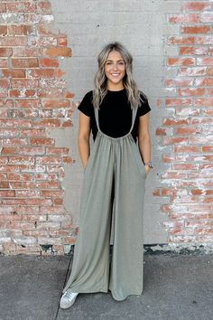 Look no further for a classic, timeless jumpsuit! The Brennan Jumpsuit is the perfect addition to your wardrobe. It features a solid brushed olive color, tieback, and an oversized, wide leg fit. Crafted from 96% polyester and 4% spandex, it provides a comfy fit with just the right amount of structure. Look great and feel amazing in the Brennan Jumpsuit! Saint West, Olive Color, Winter Clothes, Comfy Fits, Looks Great, Clothing And Shoes, Winter Outfits, Jumpsuit Romper, Wide Leg