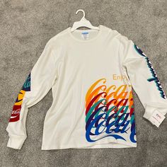 Nwt Men’s Medium Champion Long Sleeve Shirt. White With Colorful Coca-Cola Lettering. Never Been Worn, Smoke Free Home. Vintage Long Sleeve Shirts Men, White Long Sleeve Shirt Outfit, Long Sleeve Shirt Outfits, Apparel Design Inspiration, Long Sleeve Workout, Grey Long Sleeve Shirt, White Long Sleeve Shirt, Mens Long Sleeve Tee, Crew Neck Shirt