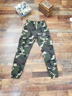 "Vintage highwaisted camo skinny pants camo army style. Cargo pockets, elastic ankle with snap closure. Waist: 27\" Hips: 38\" Rise: 11.5\" Inseam: 29\" Length: 41\" Condition: Very good vintage condition. All Sales are final. No returns , exchanges or cancellations on orders. Please review shop policies." High Waist Camouflage Cargo Jeans For Streetwear, High Waist Camouflage Cargo Jeans For Fall, High Waist Camouflage Combat Pants, High Waist Military Pants For Streetwear, High Waist Military Style Streetwear Pants, Military High Waist Pants For Streetwear, Military Cargo Pants With Elastic Waistband, Military Cargo Pants With Elastic Waistband For Streetwear, High Waist Camouflage Utility Pants