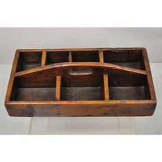 an old wooden box with compartments on it